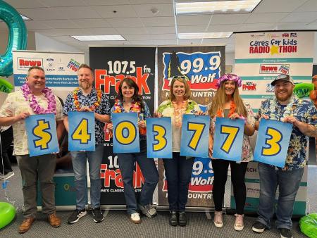 A group of adults holding large numbers that read $403,773.