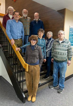 A group of adults, members of the MaineHealth Memorial Hospital Patient and Family Advisory Council, standing together on a staircase