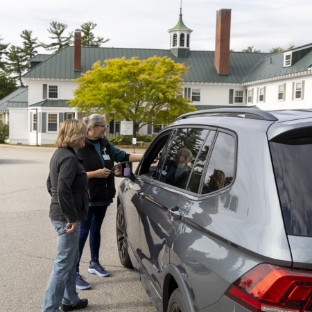MaineHealth care team members greet patients at a drive-through vaccine clinic