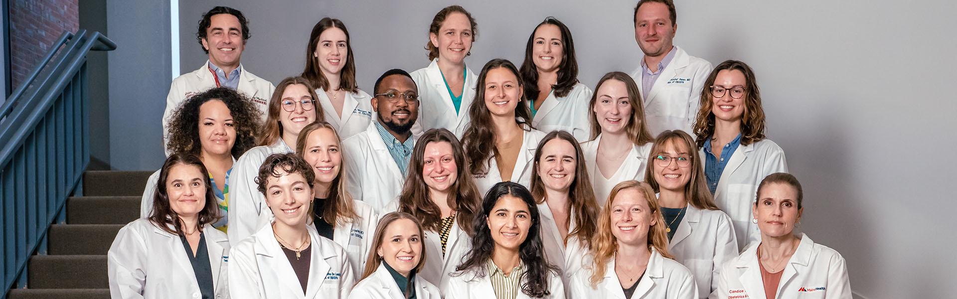 A group of OB-GYN residents standing together on a large staircase