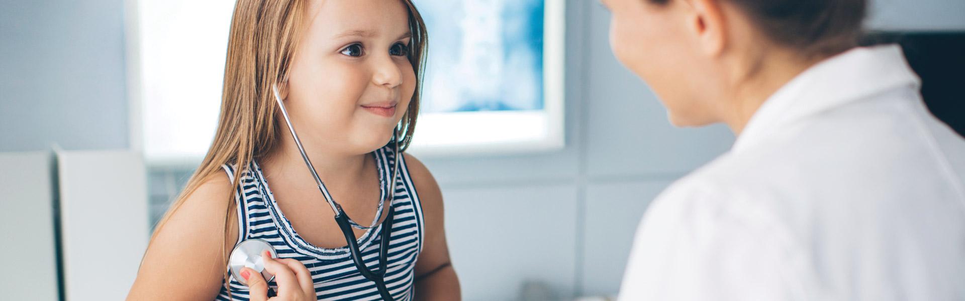 Child wearing a stethoscope