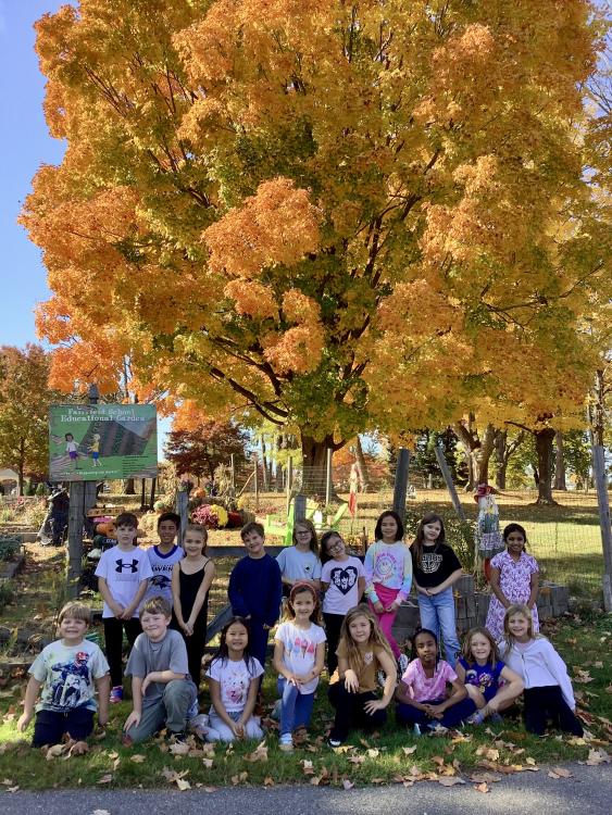 Kids sit together on a Playground for a Group Photo