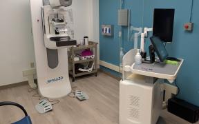 A mammography machine in a medical exam room