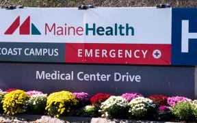 MaineHealth Mid Coast Campus exterior sign surrounded by flowers and plants