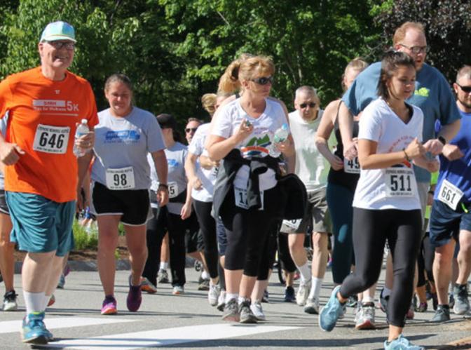 a group of men and women participating in a 5k road race
