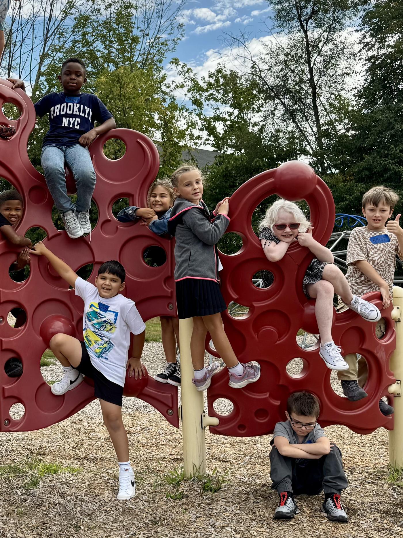 Kids play on playground equipment outside