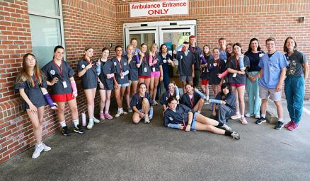 a group of students gathered outside Memorial Hospital
