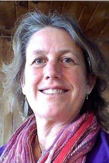 Reverend Lindy Howe is shown smiling in an interior head shot